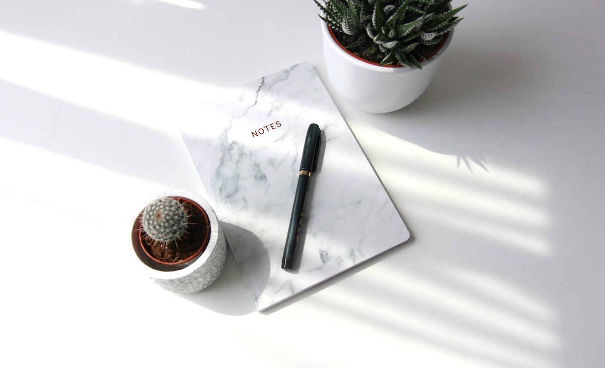 Benefits of journaling for mental health, notebook and coffee notebook on table