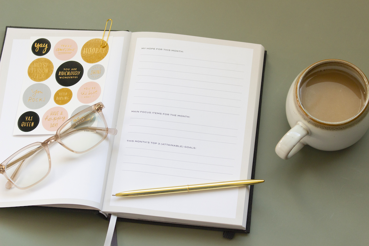 Benefits of journaling as a mum, plus 50 journal prompts journal with glasses and cup of tea