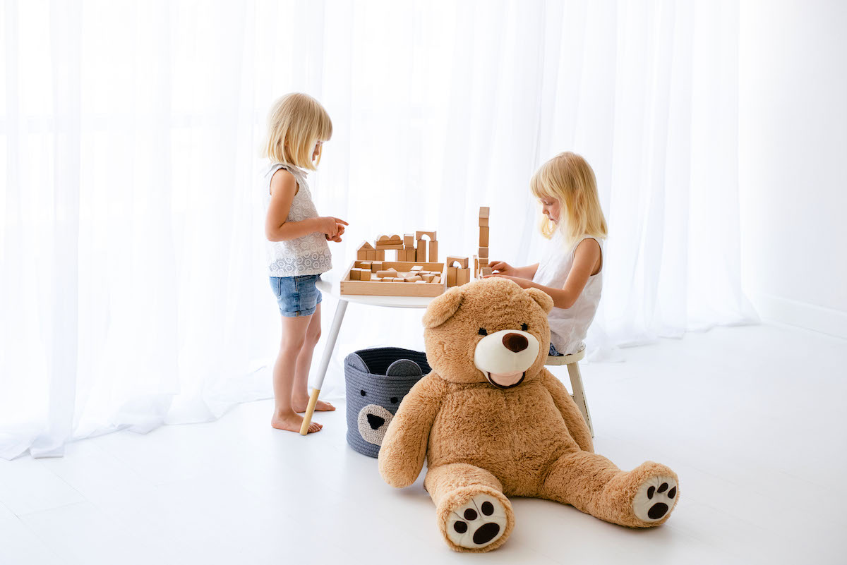 How to set boundaries for kids - 2 girls and a large teddy bear sitting around a table playing blocks.