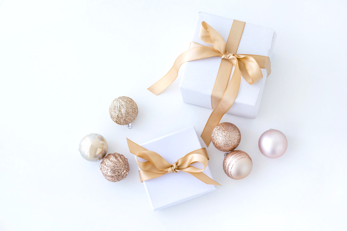 Organising and storing holiday decorations - pink baubles with white gifts wrapped in gold ribbon.