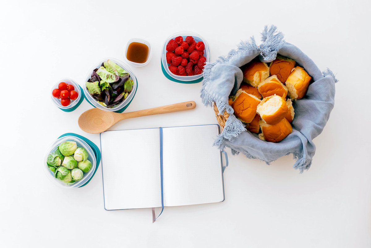10 family meal planning tips - fruit and vegetables, bread, planner on table.