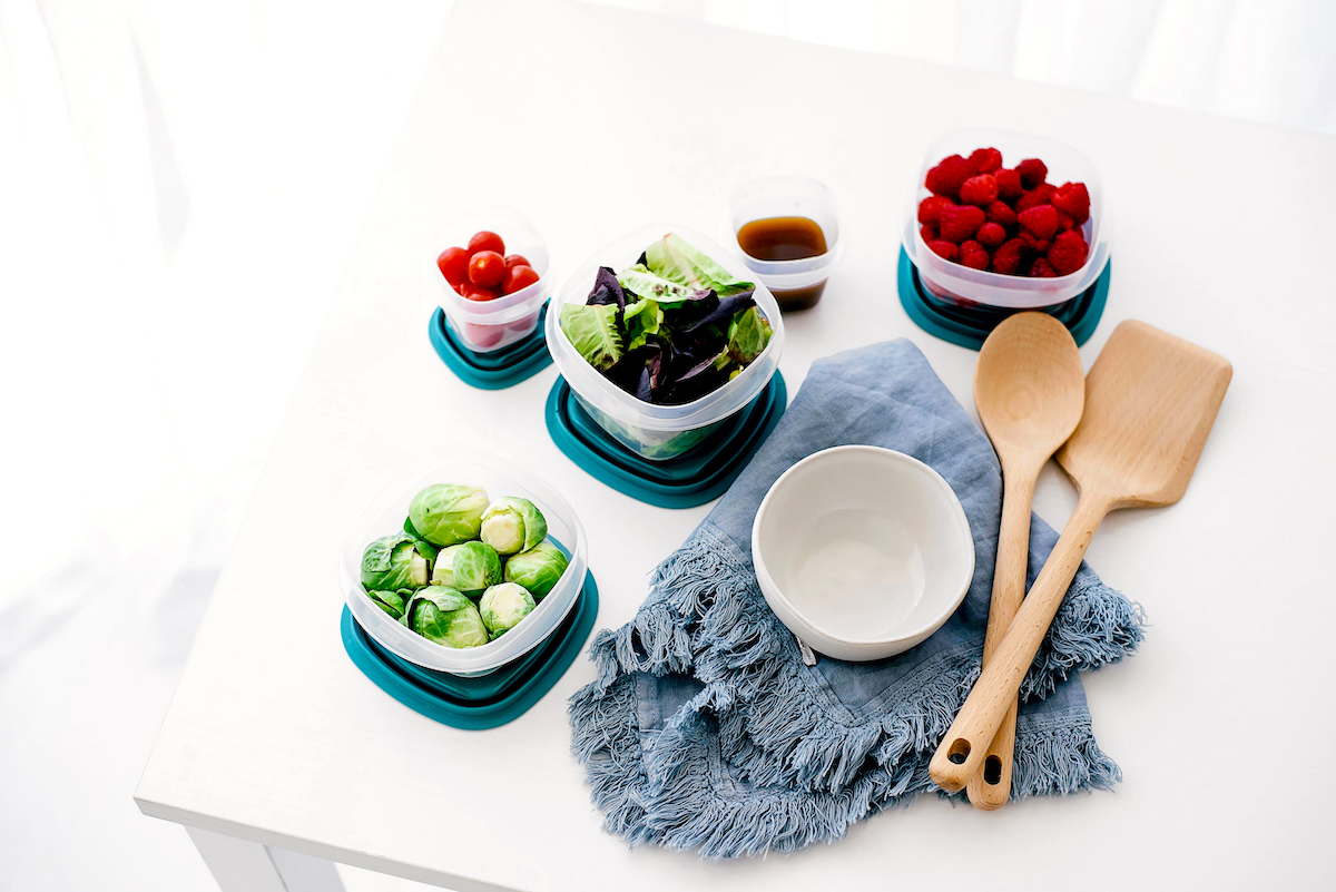 10 family meal planning tips - fruit and vegetables, wooden utensils, cloth on a table.