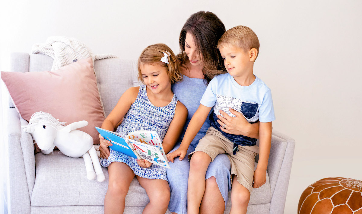 5 tips to make your child's clothes last longer - mother reading to son and daughter.