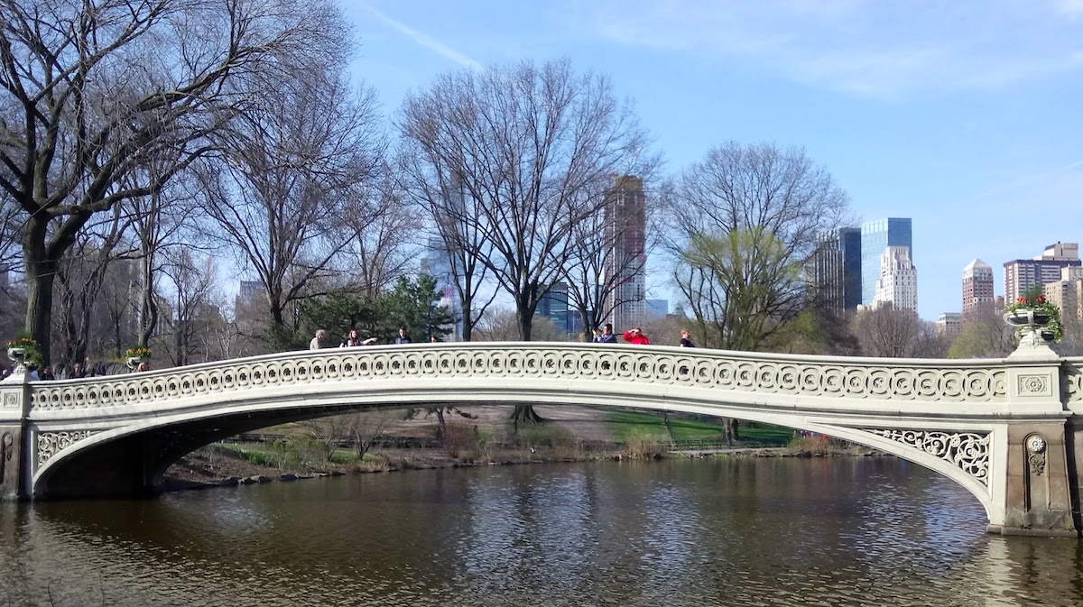 A weekend in New York - Central Park bridge with people walking over it.