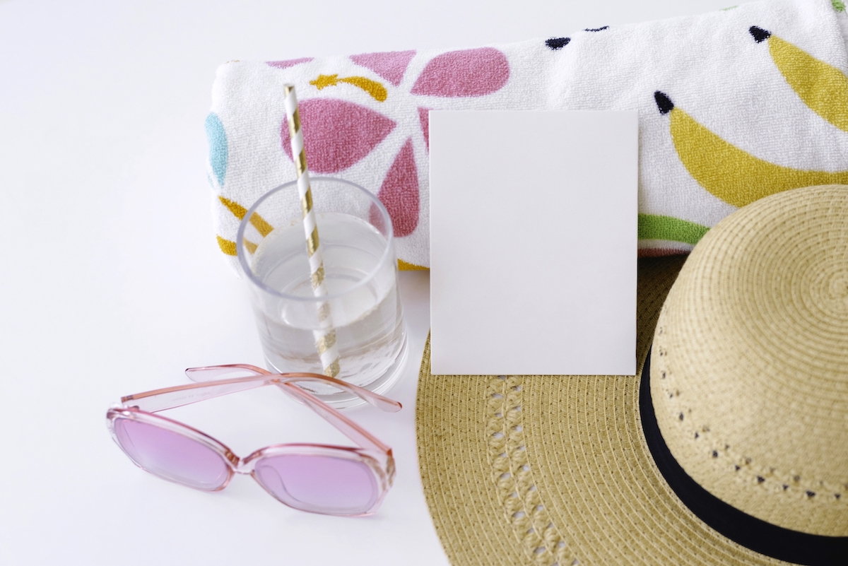 How to travel with kids - hat, paper, towel and sunglasses.