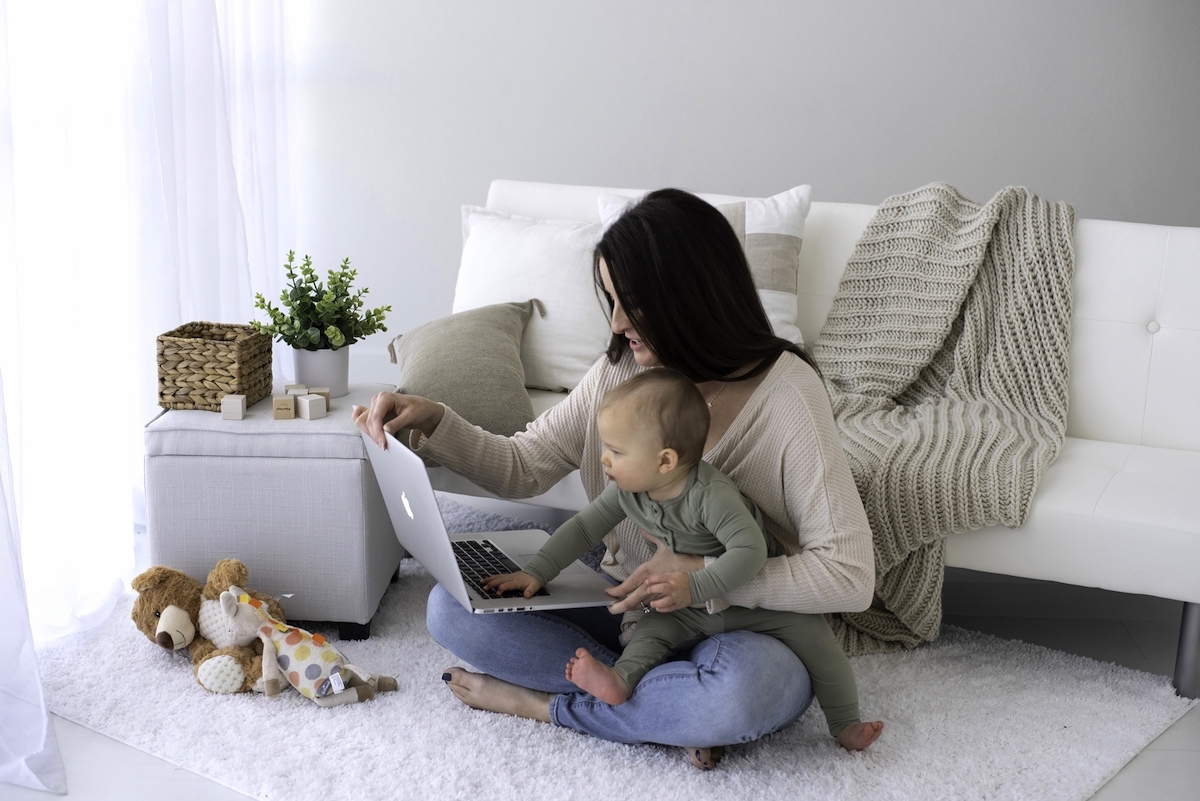 Strategies for working mums to overcome mum burnout - mum on floor with laptop and baby.