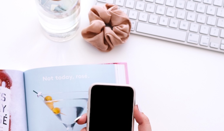 woman holding a phone, magazine, keyboard - one of the things you can do in 20 minutes.