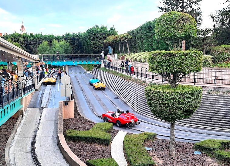 Kids driving cars on the Autopia car track at Disneyland Paris - one of the things to see when visiting Disneyland Paris in one day.