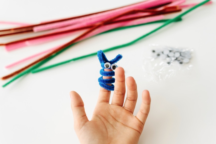 Young child playing with arts and craft pipe cleaners - some of the preschool activities you can try.