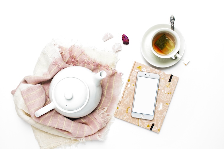 A teapot, scarves, tea, phone, and a notebook - a way to collect ideas to overcome mum burnout.