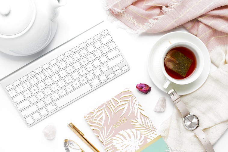 A keyboard, teapot, scarf, tea, and a notebook - a way to collect ideas to overcome mum burnout.