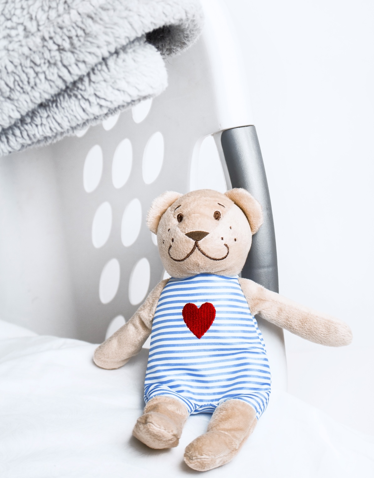 Laundry basket with a teddy bear in it - one of the joys of mum life.