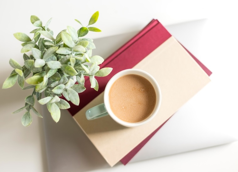 Plant, 2 notebooks, cup of tea - items you can use when finding time for yourself.