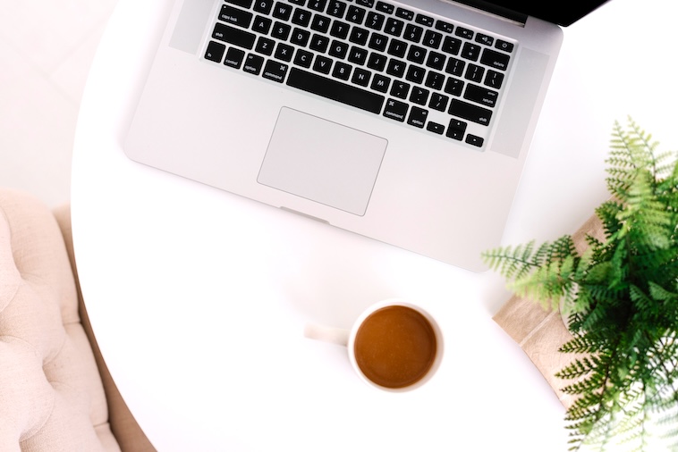 Coffee table, laptop, plant, coffee, pink couch - some supplies you need to become an organised mum.