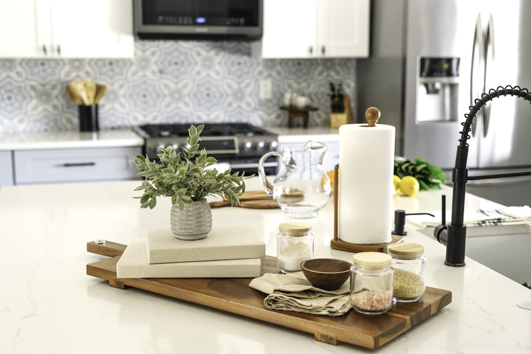 Kitchen with plants, black tap, and decor - things to refresh a kitchen to increase the value of your home.