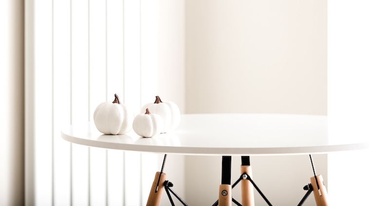 Coffee table with 3 ceramic pumpkins on it - decorating a home is a great home improvement idea.