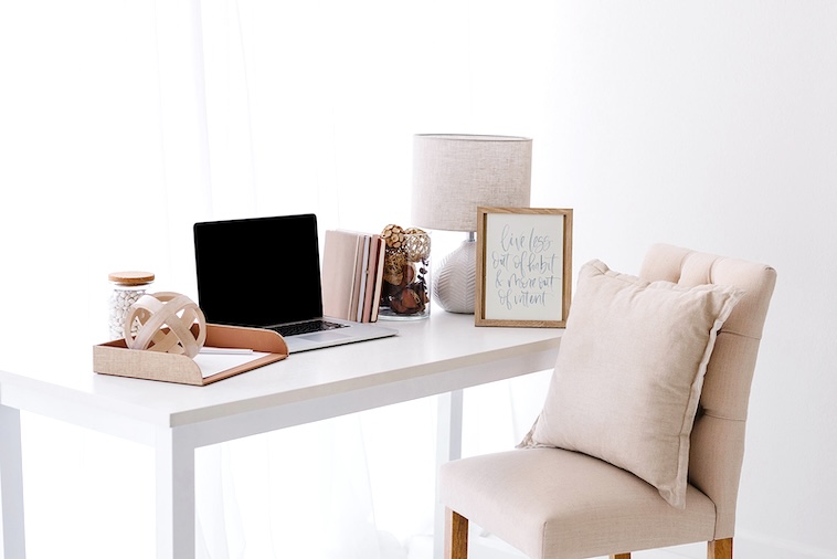 Desk with laptop, lamp, decor - practical home upgrades to make to an office.