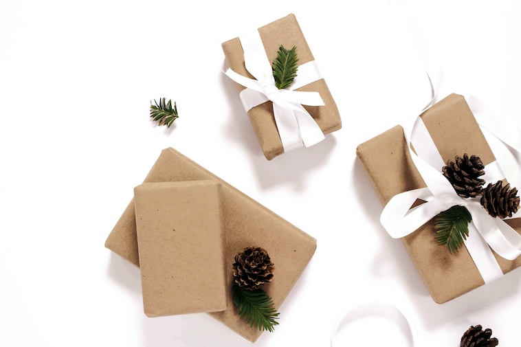 Presents wrapped in paper with pinecones - items you can use in your Christmas traditions for kids.