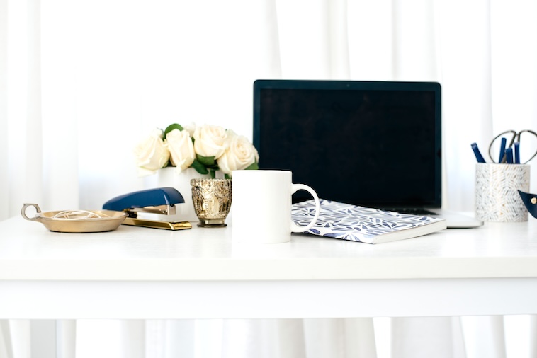 Laptop, stationery, mug - things to use when writing word of the year ideas.