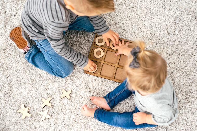 Kids playing naughts and crosses - family goals can include playing games.