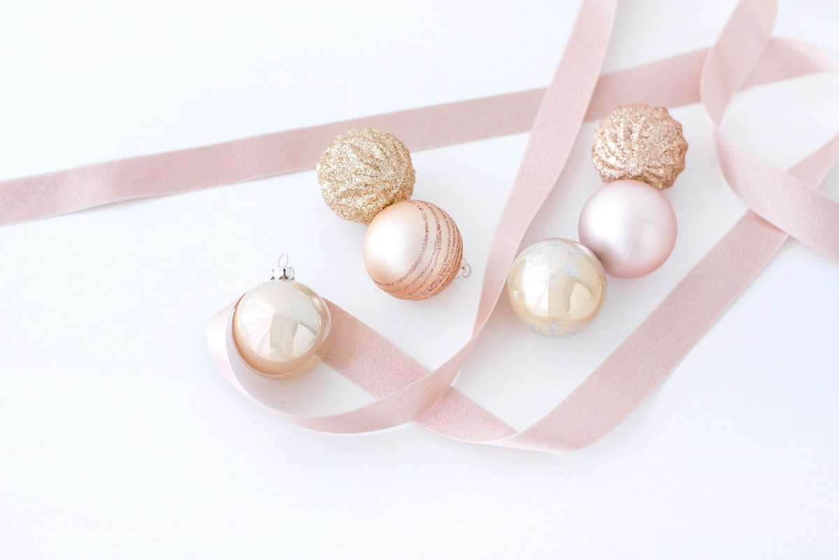 Organising and storing holiday decorations - pink Christmas baubles with pink ribbon.
