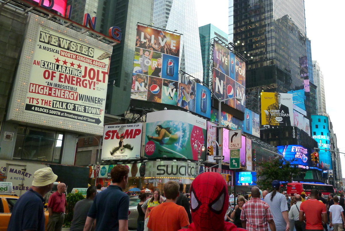 A weekend in New York - people walking in Times Square with Spiderman in the front.