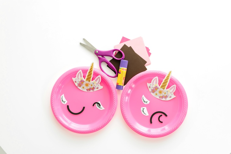 2 pink paper plates, with craft materials - one of the easy arts and crafts activities for kids.