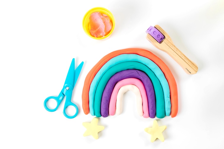 Rainbow made of Play Doh, scissors, Play Doh accessories - some of the things you can buy to prepare for school holidays.