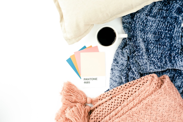 4 Pantone colour cutouts, pillow, coffee, blue blanket, pink blanket - things you need in the design process of building a family home.