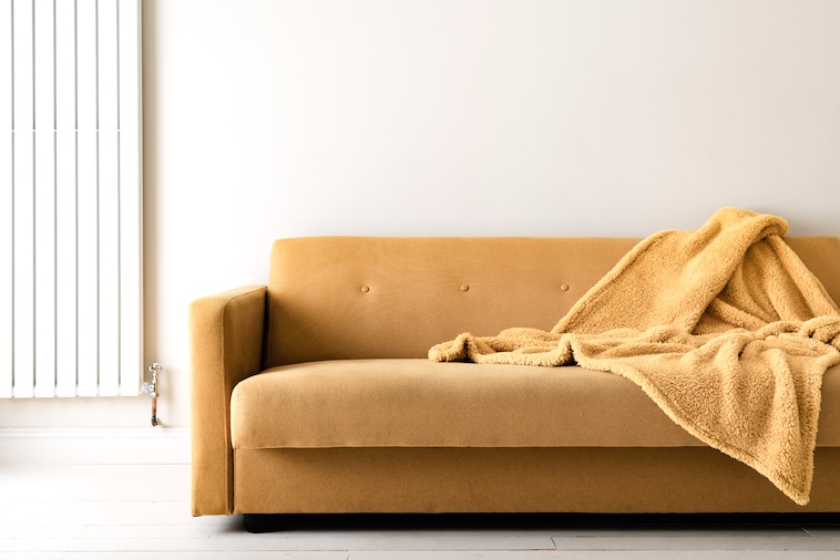 Yellow sofa with yellow throw - decorating a home is a great home improvement idea.