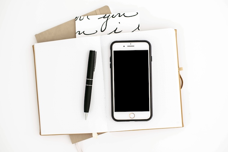 Notepad, pen, phone - things you need to help with family organisation.